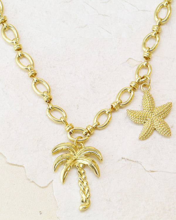 cadena con dije de palmera y estrella de mar